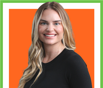 Cassie Wyatt from SERVPRO photo on white wall, female employee with blonde hair